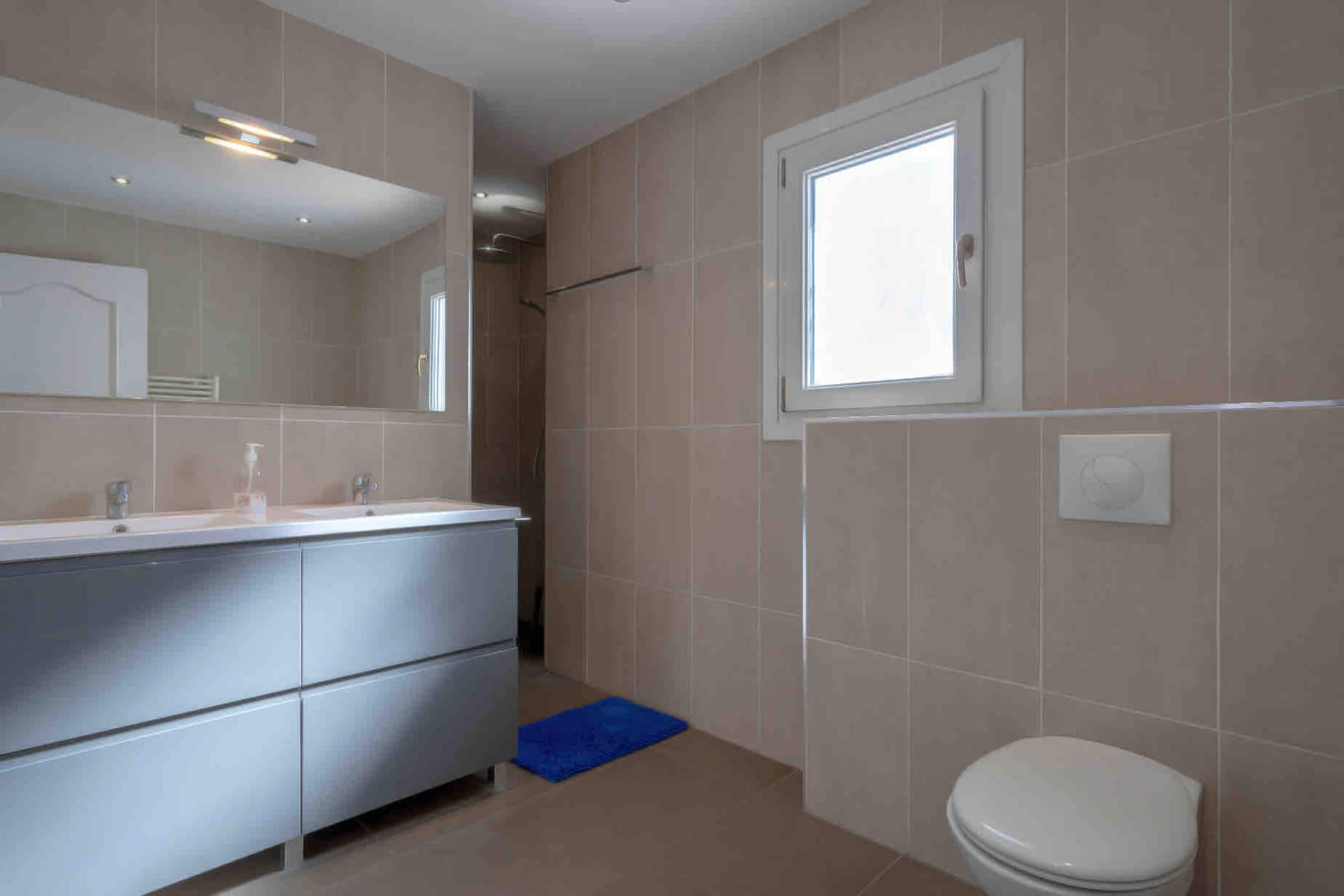 Bathroom with double vanity and walk-in shower