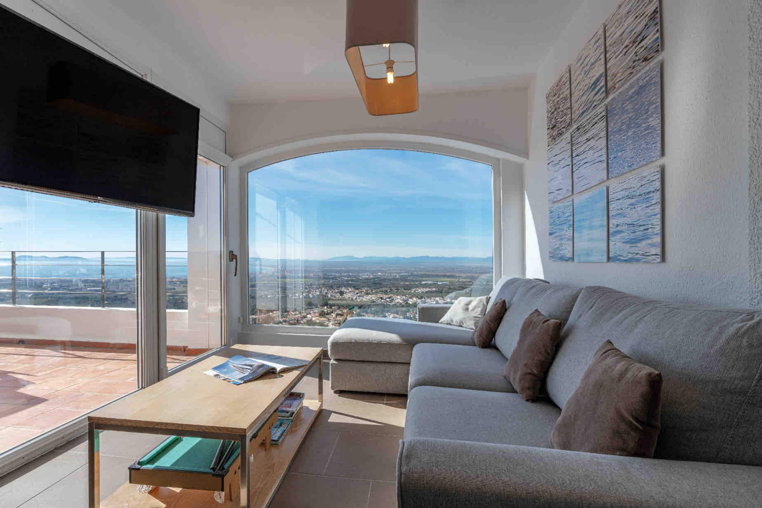 Living room sofa beside the floor-to-ceiling panoramic window