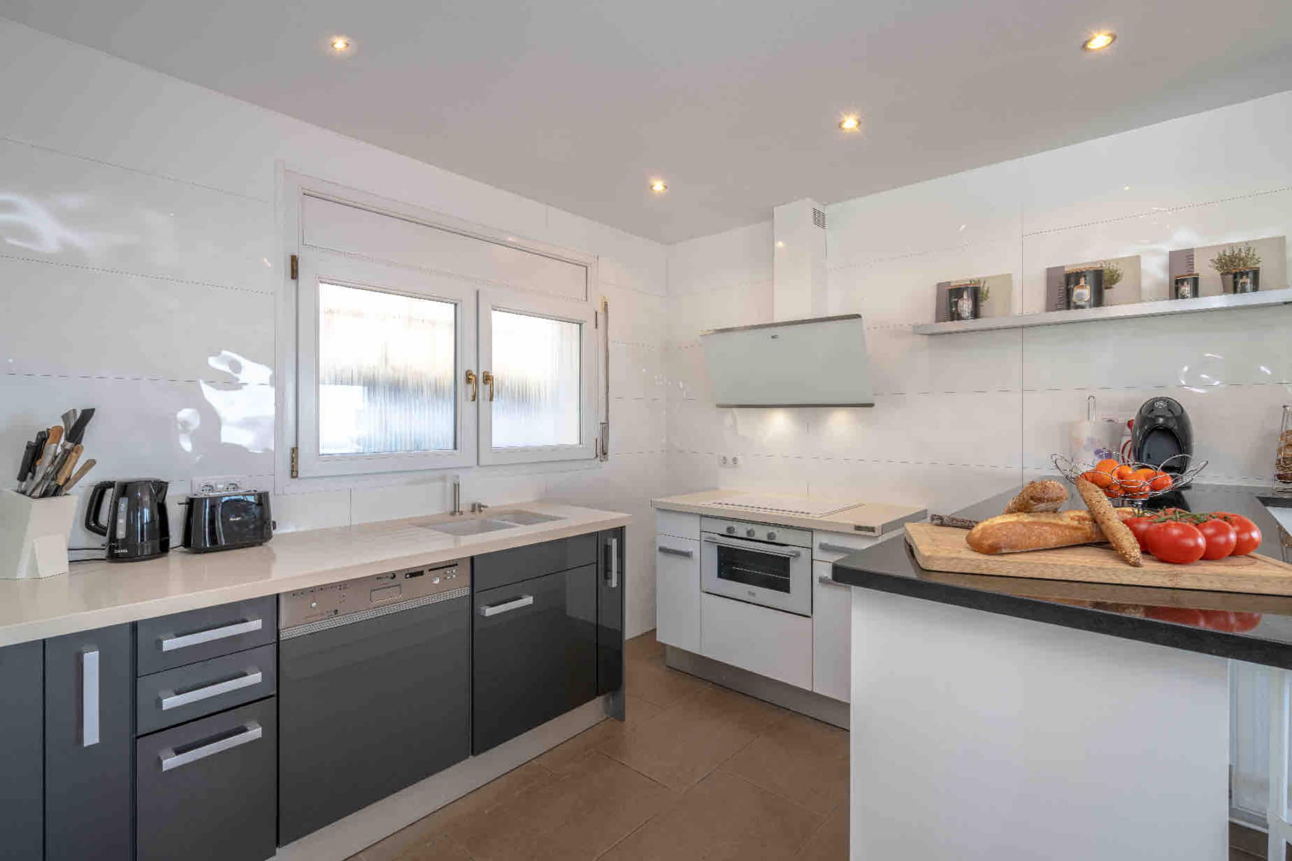 Bright kitchen with island and white cabinetry