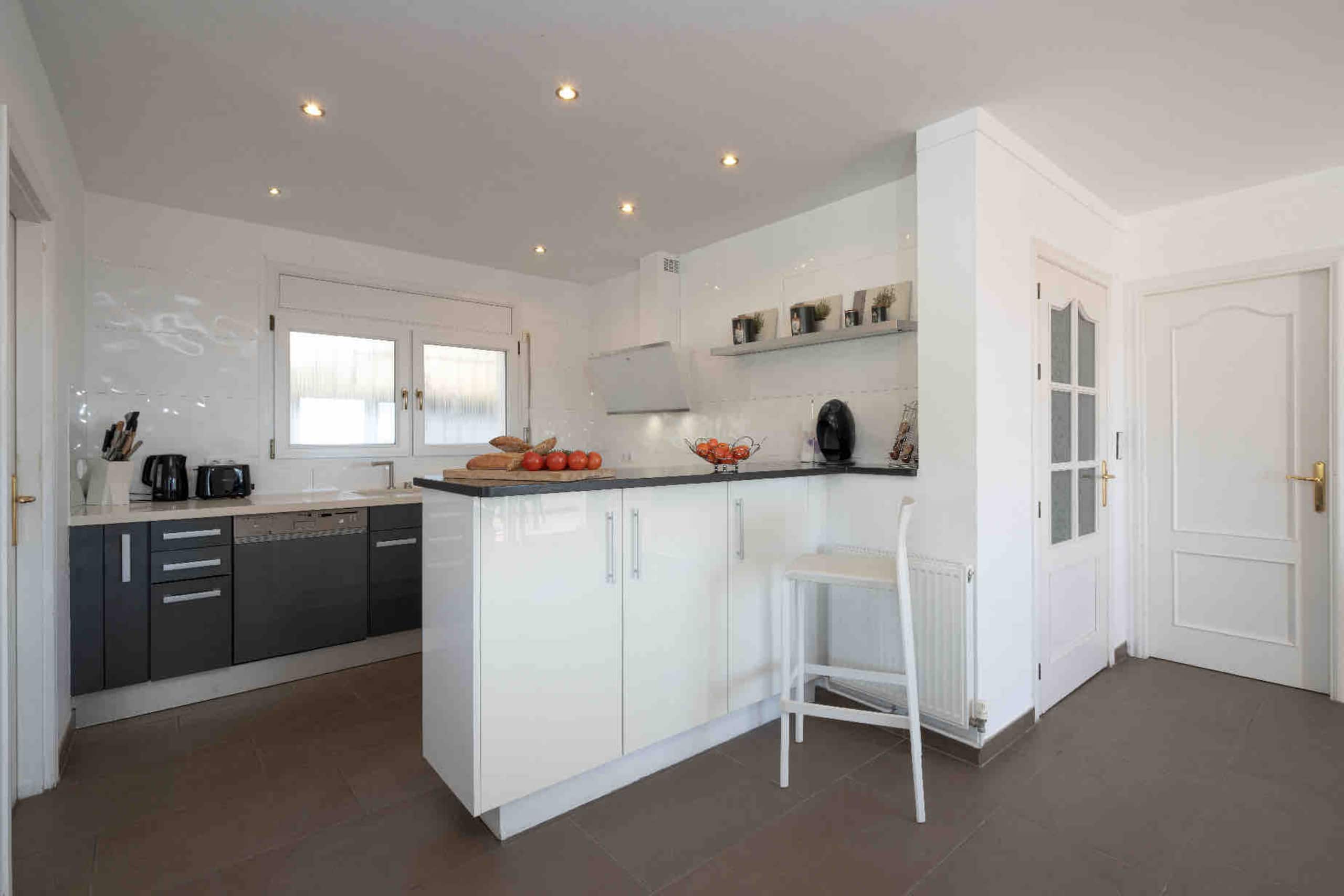 Kitchen counter with breakfast stool and pantry