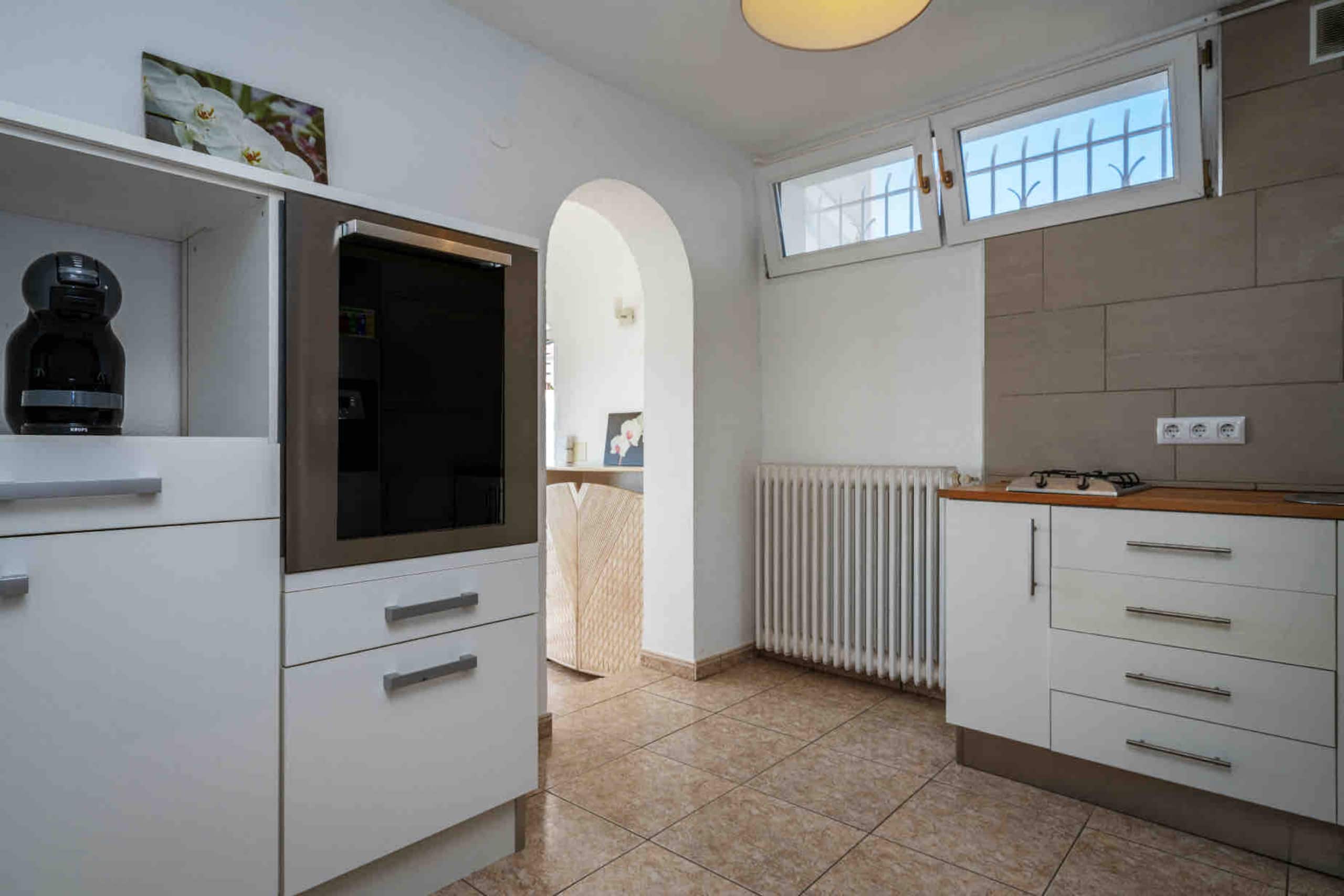 Second kitchen with archway through to the entry