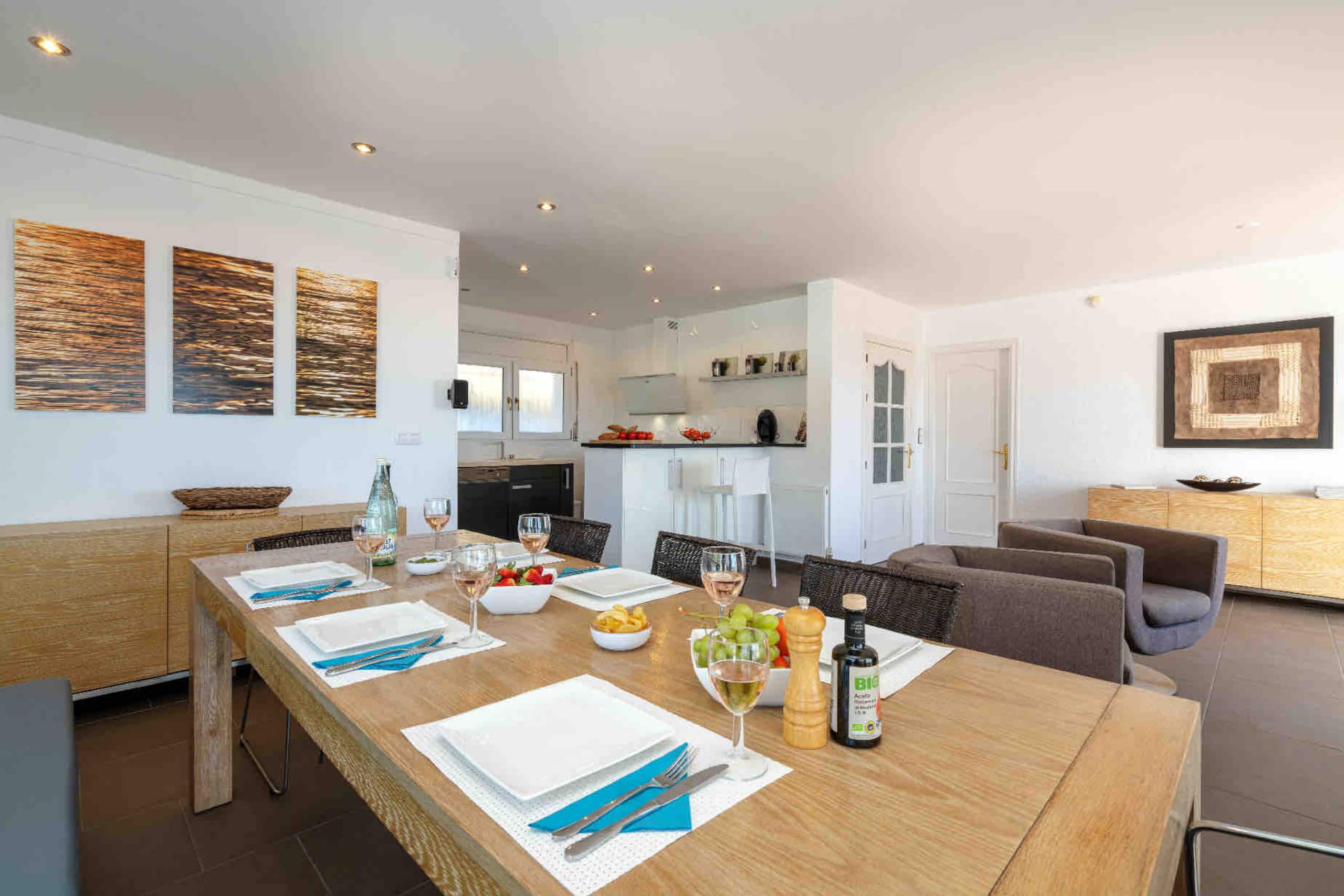 Open dining and living area with original artwork