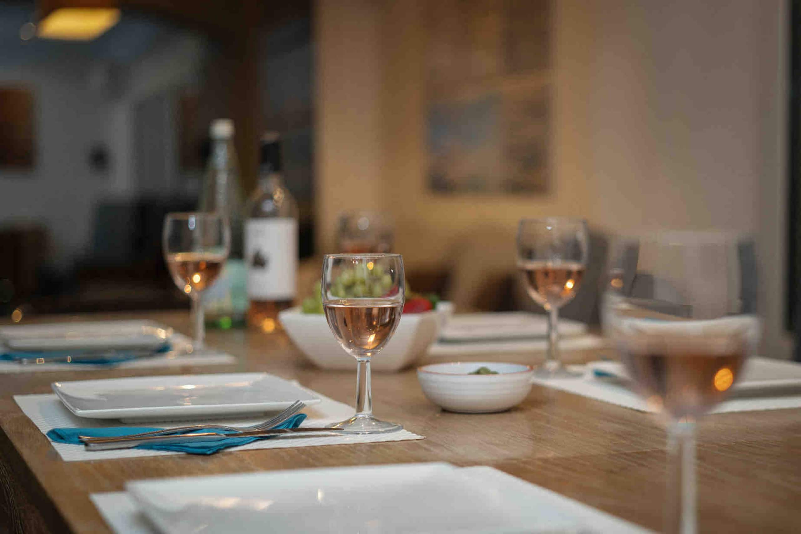 Wine glasses set on the dining table at golden hour