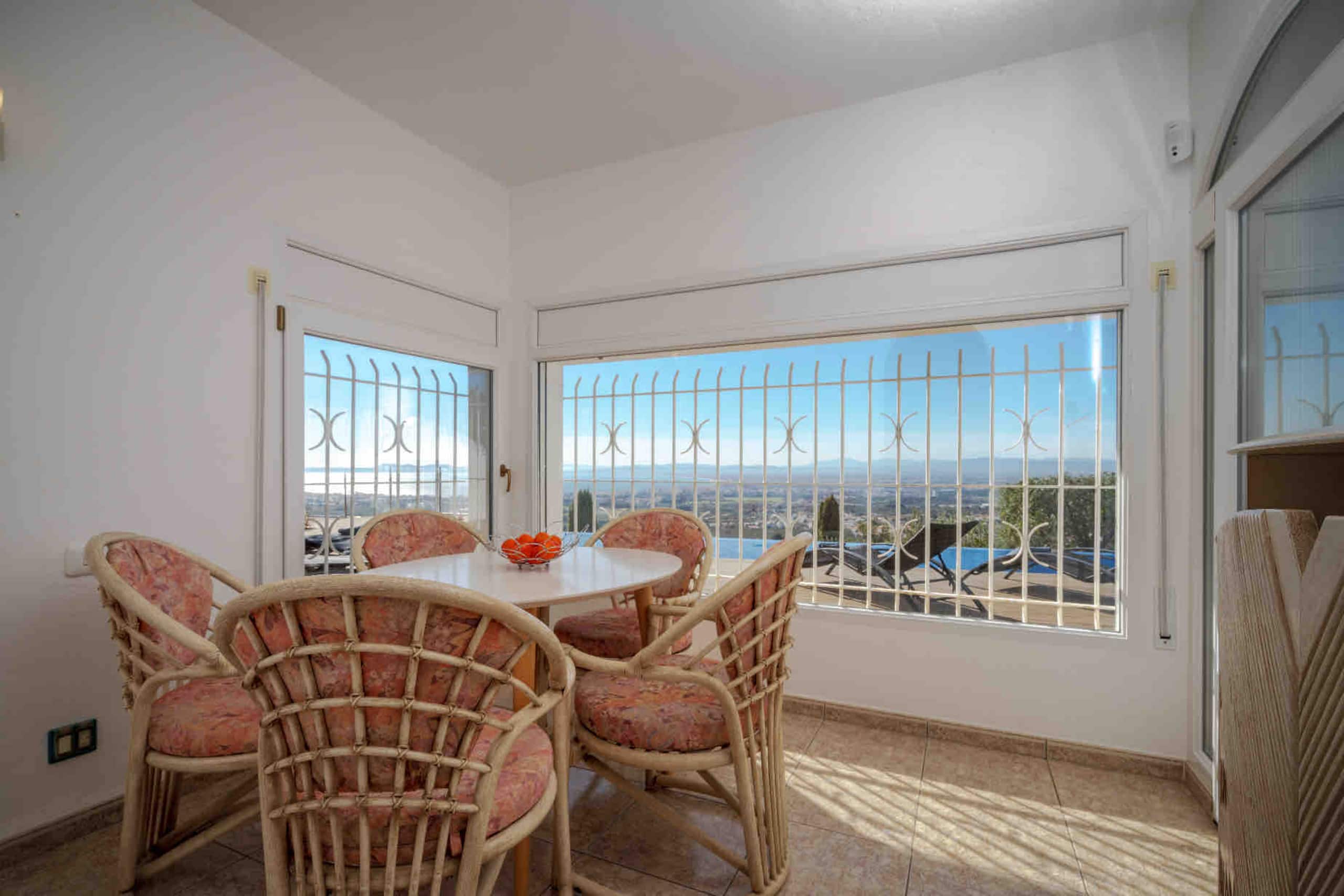 Sun room with rattan chairs and panoramic view