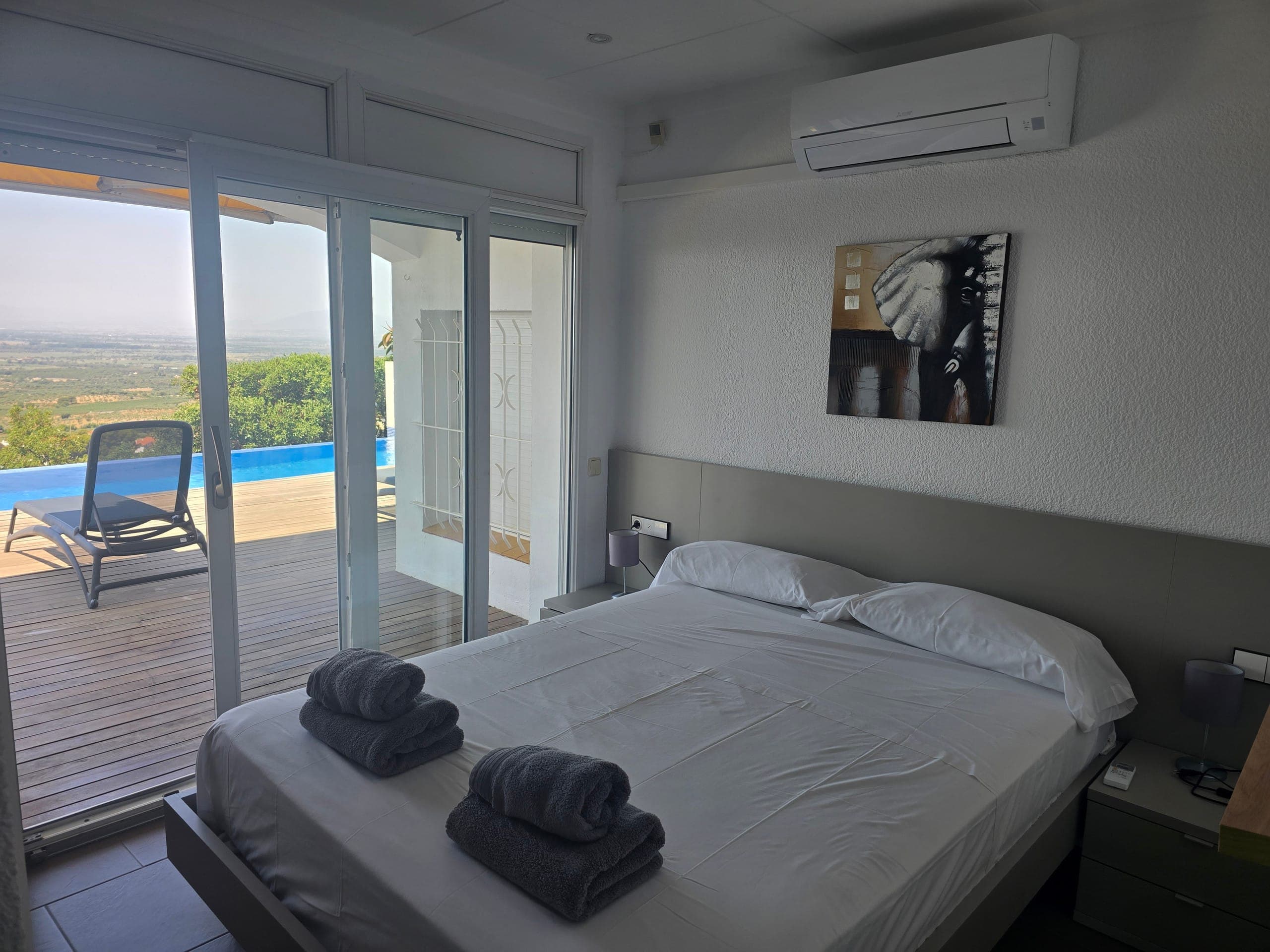 Master bedroom with sliding door to the pool deck