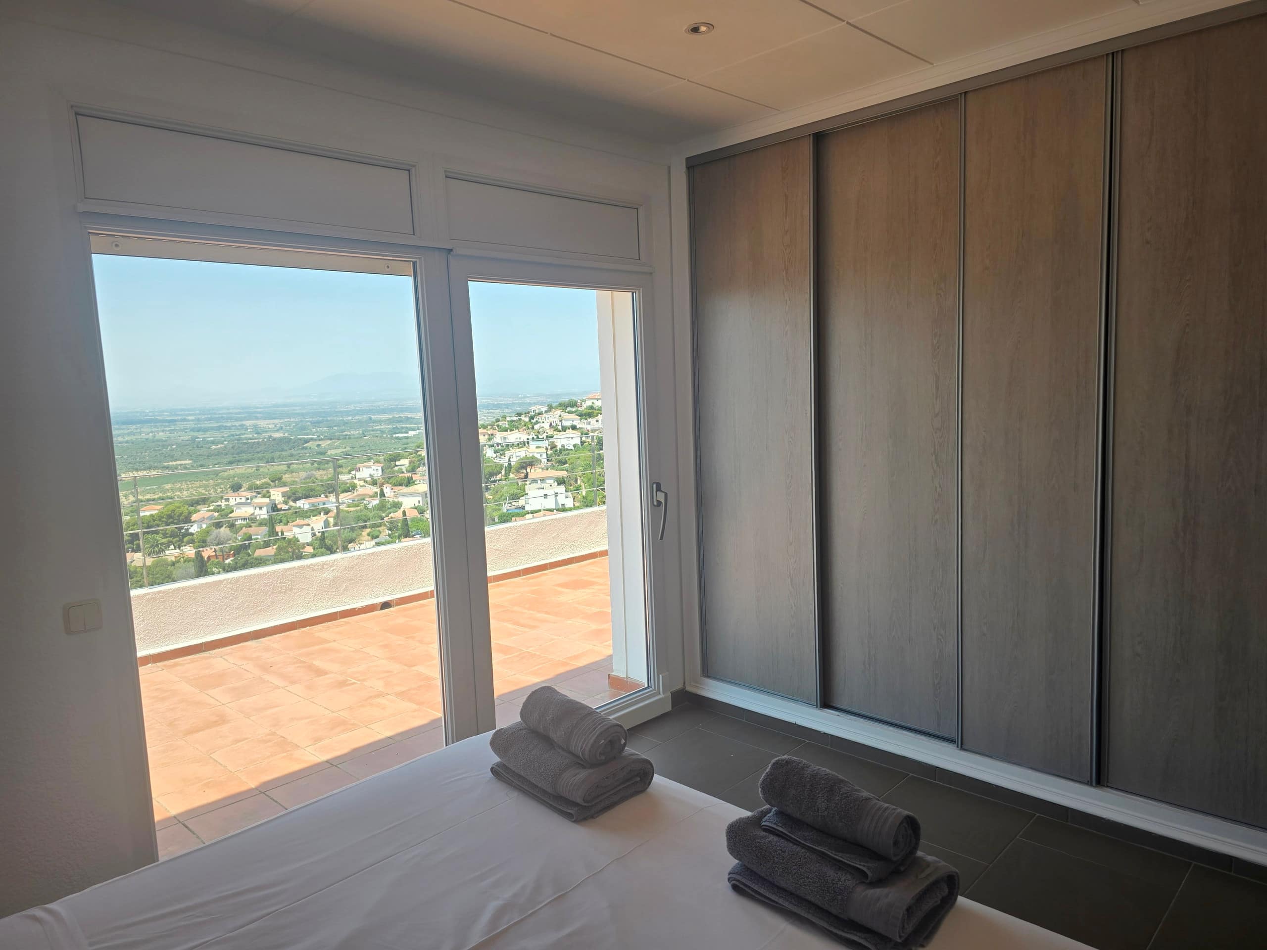 Bedroom corner with wardrobe and panoramic terrace door