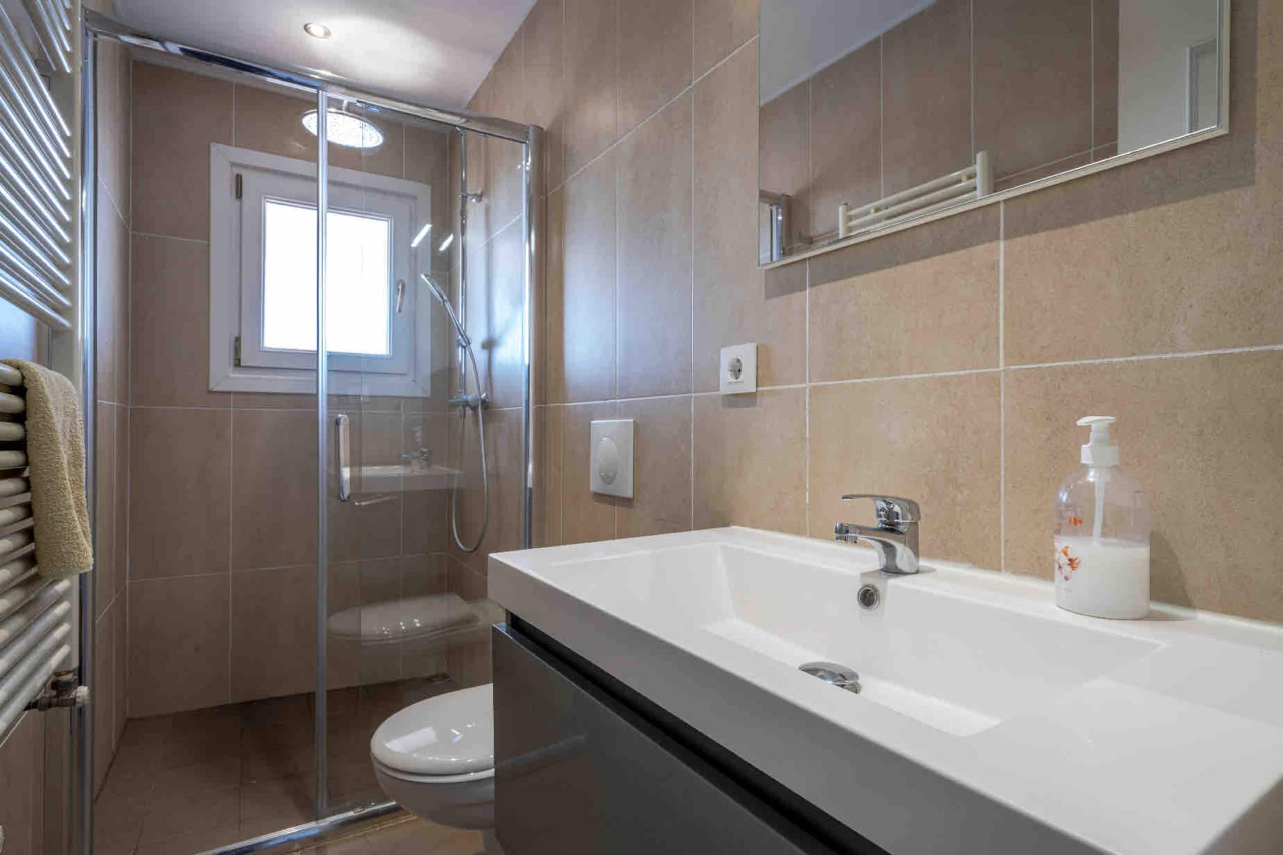 En-suite bathroom with walk-in shower and large mirror