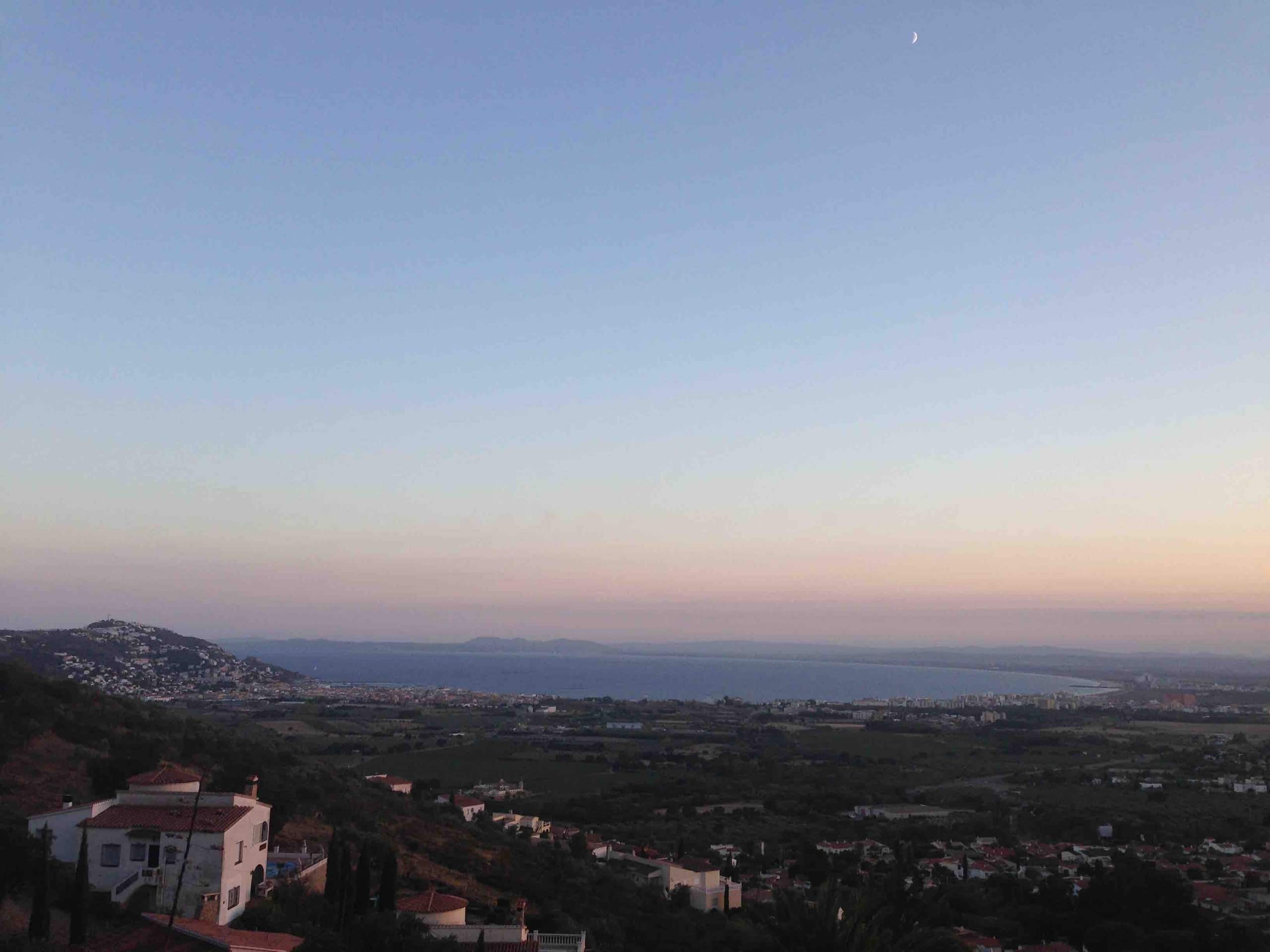 Dusk over the bay with the moon rising