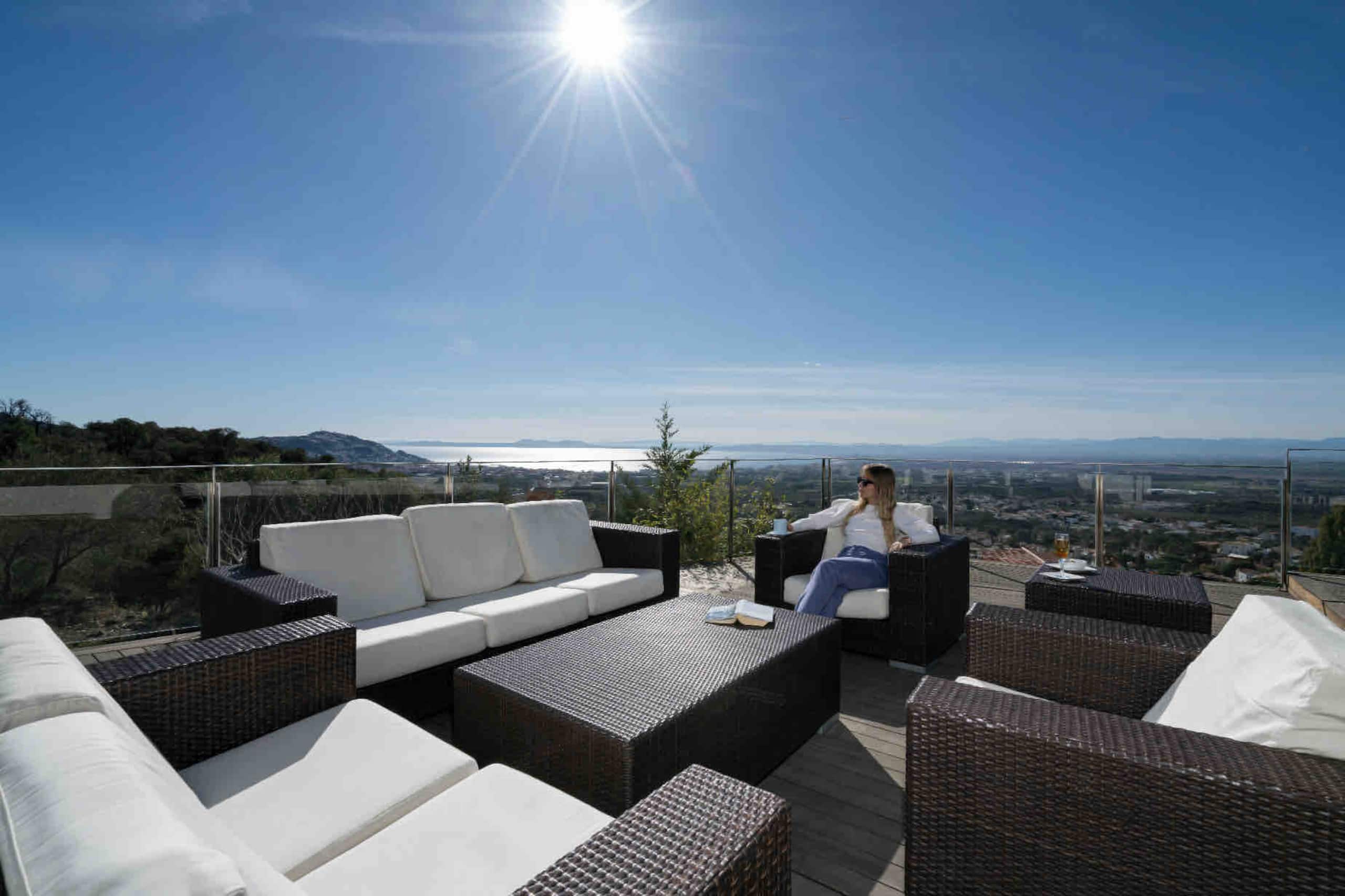 Sun-drenched terrace lounge with sea view