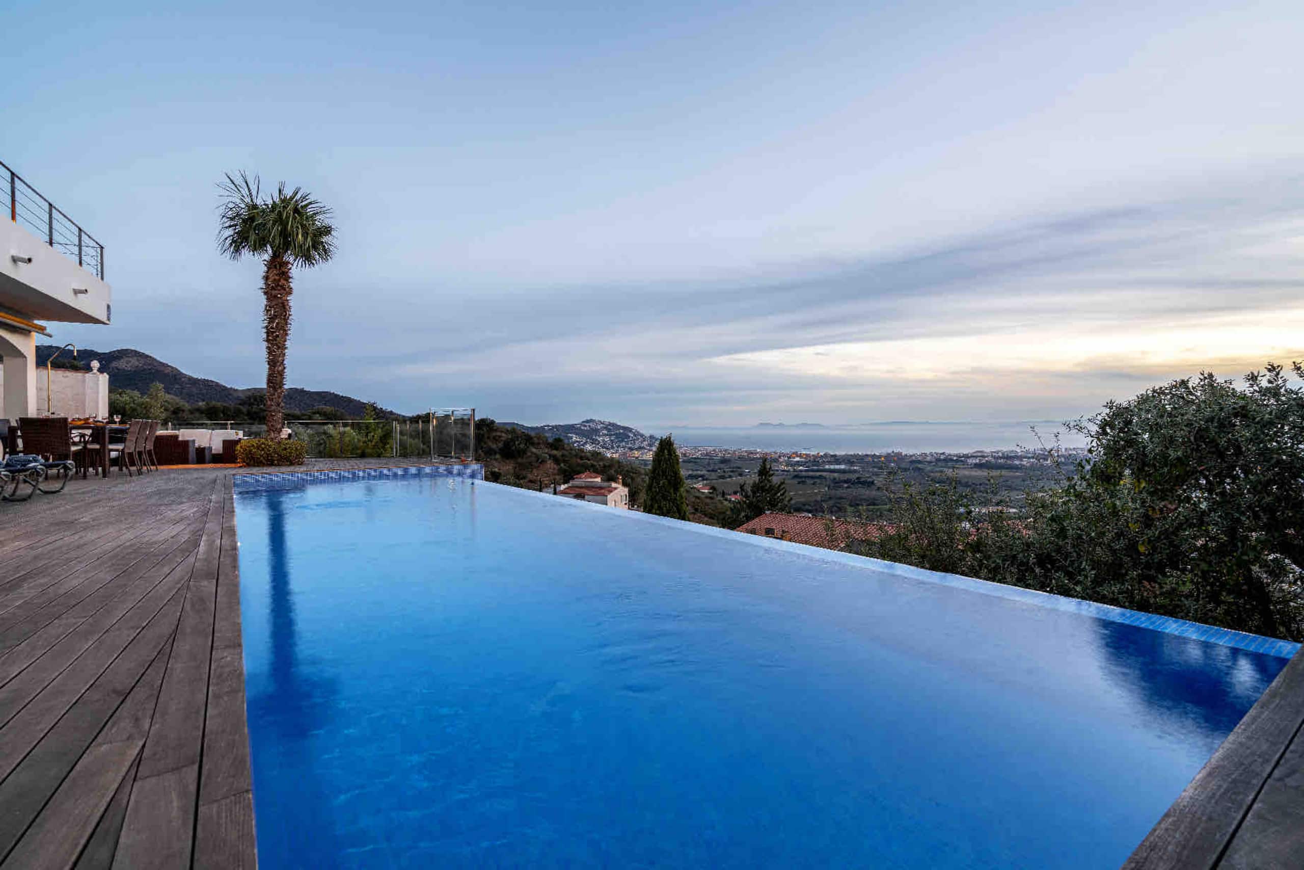 Empty infinity pool overlooking the bay at dawn