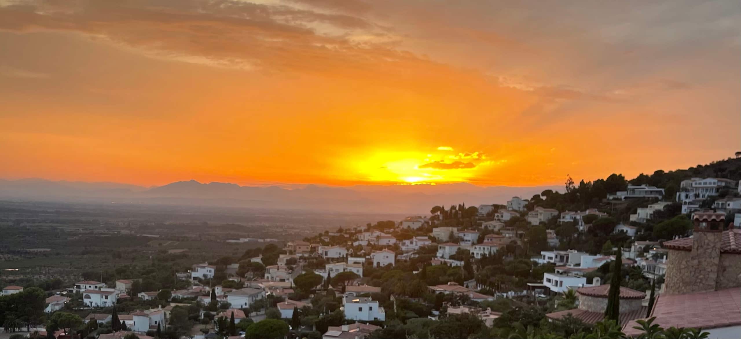 Orange Mediterranean sunset over the hills above Roses